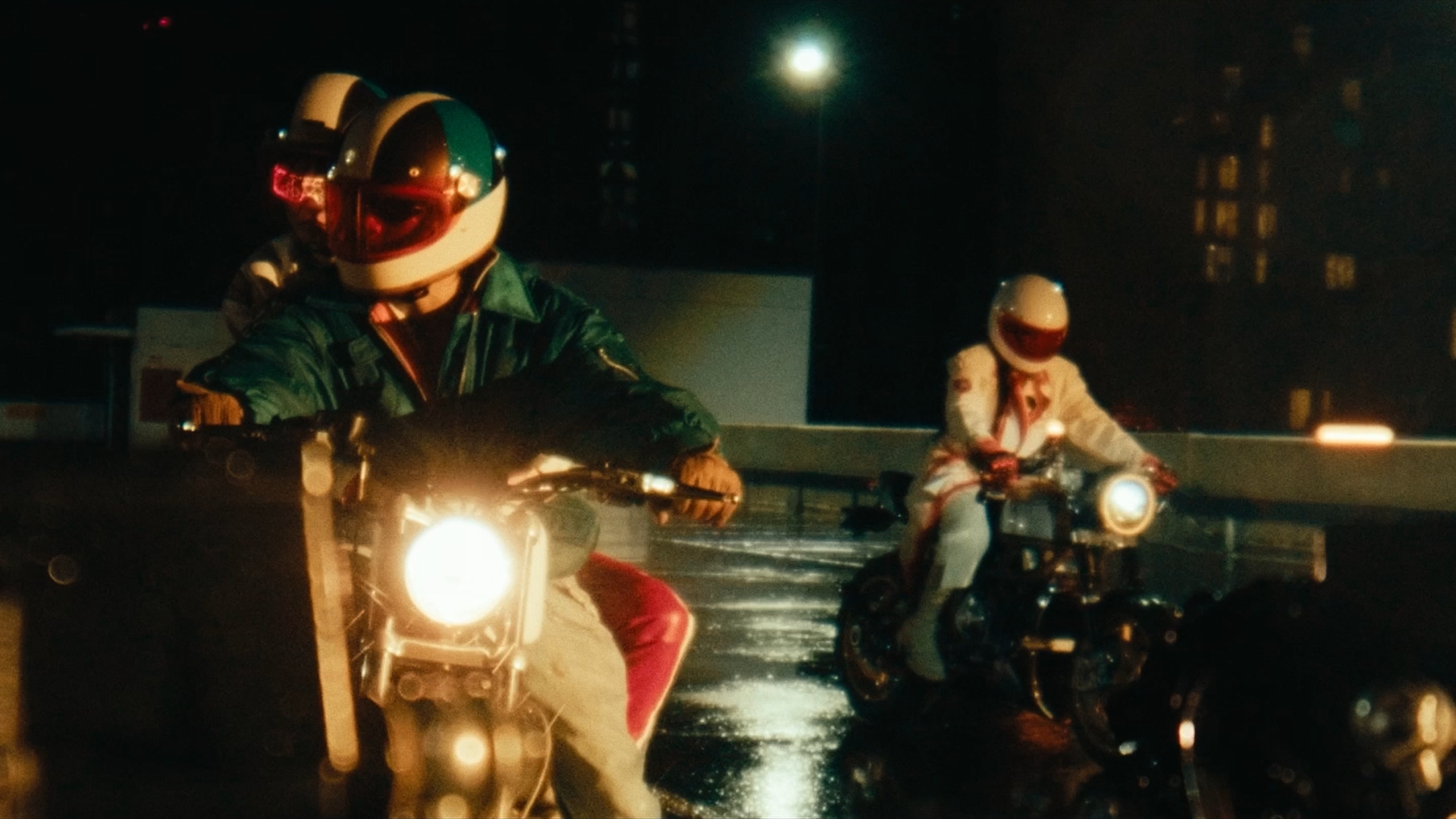 Several motorcyclists on top of a parking structure